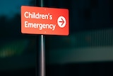 A sign with the words "Children's Emergency" and an arrow.