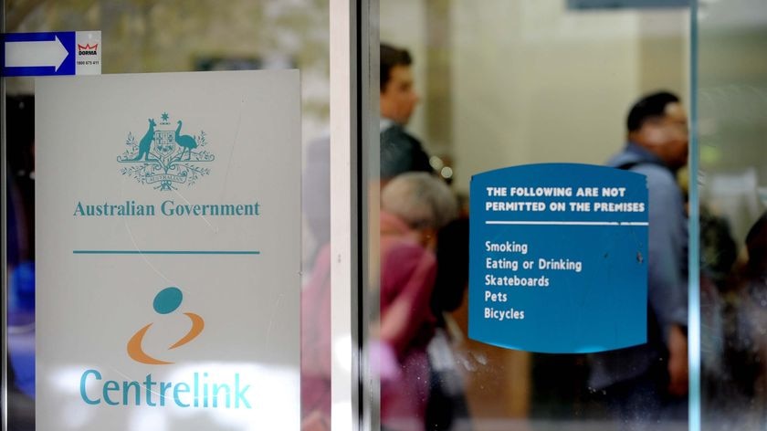 Queue inside Centrelink office but faces unidentifiable (AAP: Tracey Nearmy)