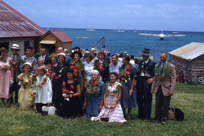 old technicolor picture of people on an island with leis.