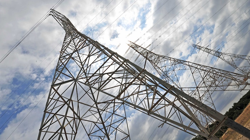 Power pylons viewed at angle from their base.