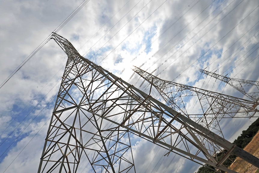 Power pylons viewed at angle from their base.