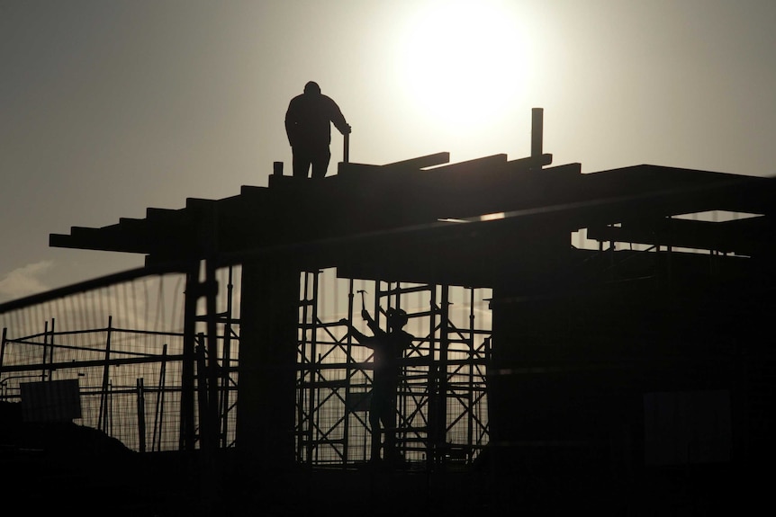 Residential construction workers at sunset