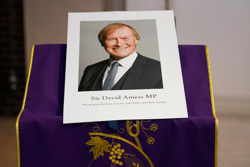 A picture of David Amess sits on an altar