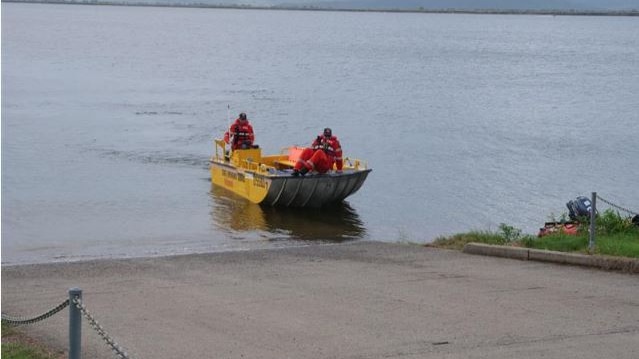 Emergency services including police and SES at a dam.