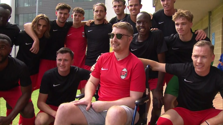 Danny Hodgson surrounded by soccer team mates