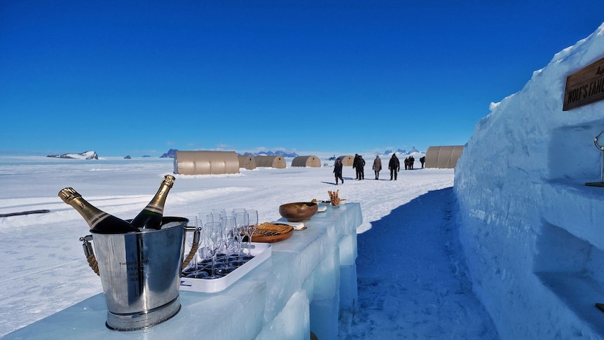 An ice bar set up with champagne and food at a luxury campsite on Antarctica. 