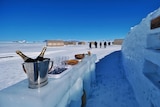 An ice bar set up with champagne and food at a luxury campsite on Antarctica. 