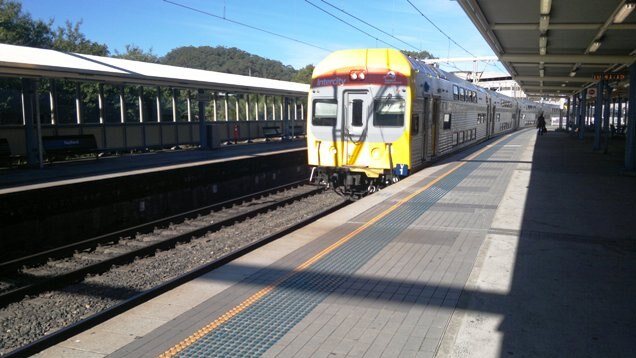 A train approaches a station platform.