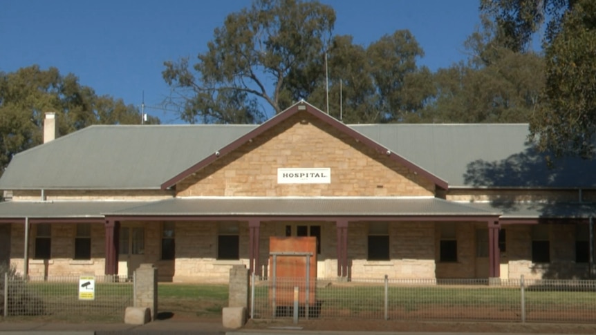Single story natural brick building with wide verandahs, the Wilcannia Hospital 