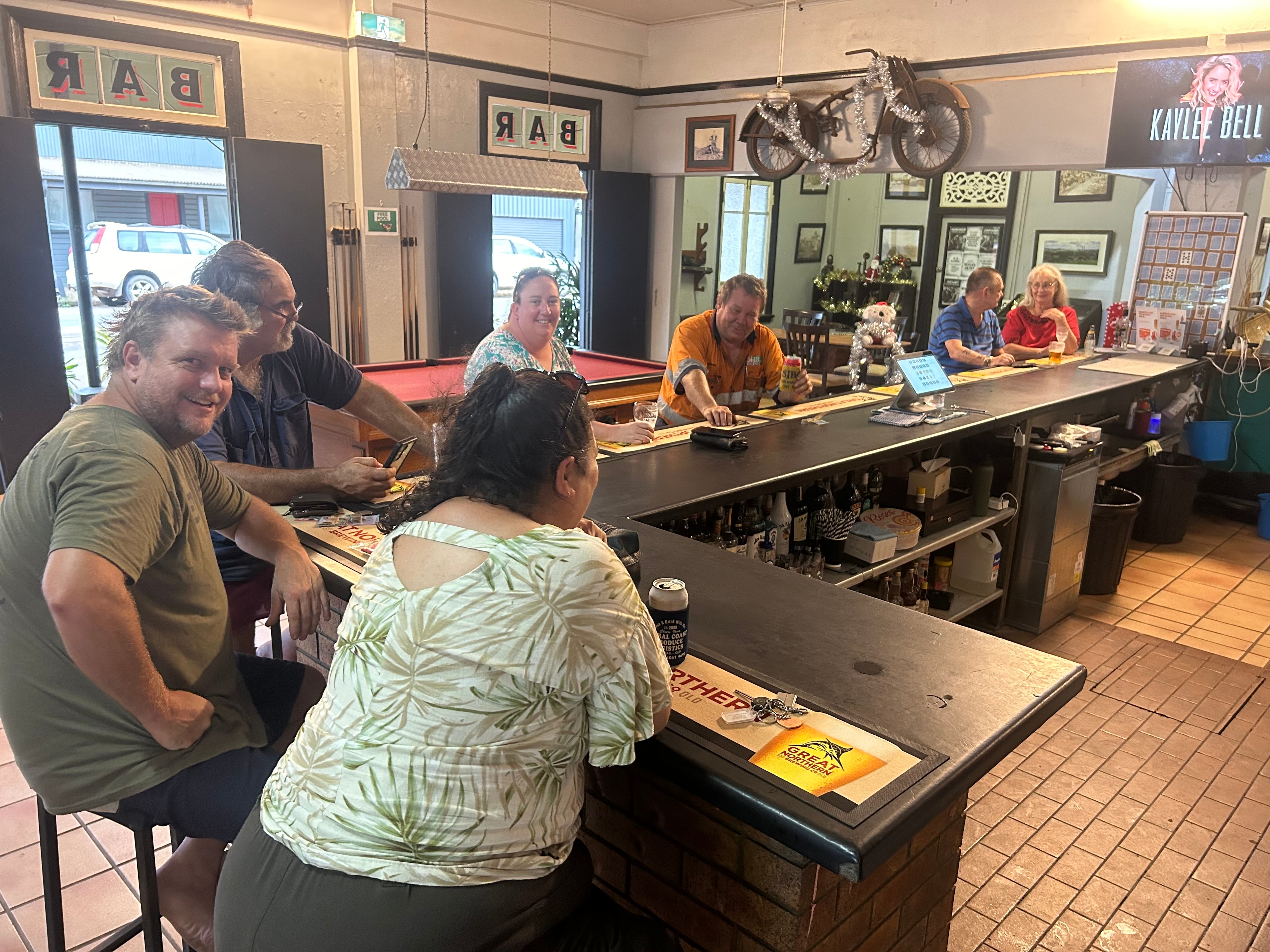 locals sitting at the bar of a country pub