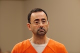 A close up shot of Larry Nassar in court wearing an orange jumpsuit.