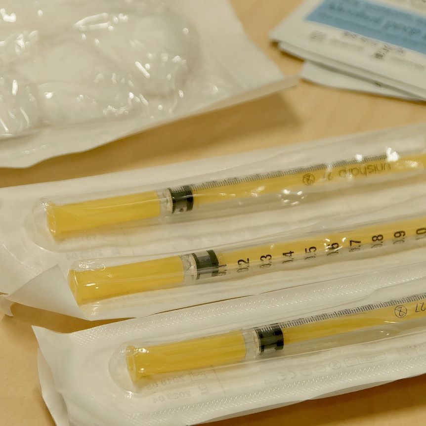 Three yellow syringes in a row 