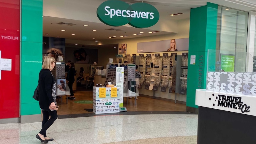 A woman walks in front of Specsavers at West Lakes.