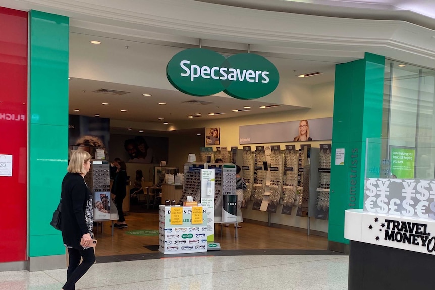 A woman walks in front of Specsavers at West Lakes.