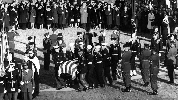 The Honour Guard approaches JFK's grave site at Arlington National Cemetery.