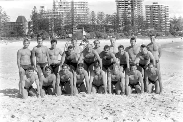 black and white photo of men at beach