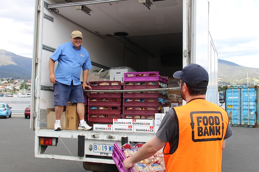 Volunteers loading donated food bound for community centres