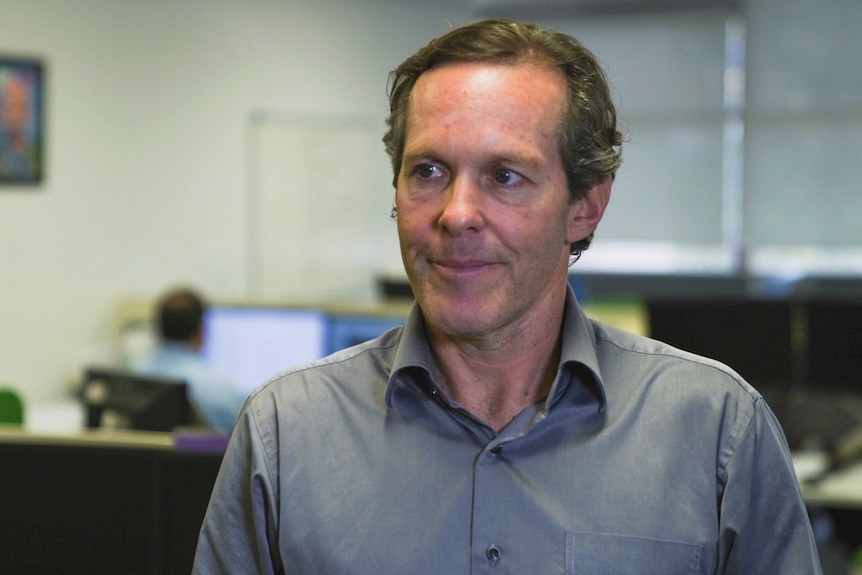 Head and shoulder photo of Tom Warner sitting in an office.