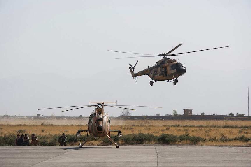 Afghan Air Force helicopters come and go at the Kunduz airstrip.