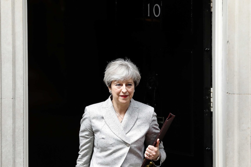 Theresa May walks out of 10 Downing Street.