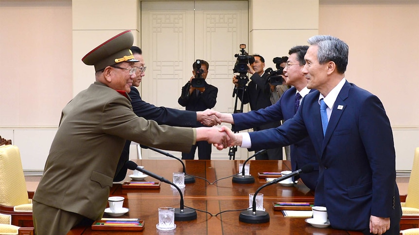 South Korea officials shake hands with North Korea