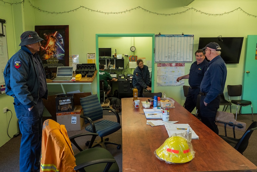 A group of firefighting volunteers in a communications room.