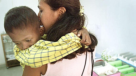 A boy with AIDS awaits treatment in Thailand.