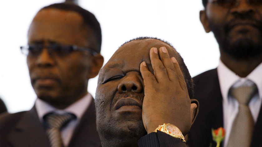 Zimbabwe Prime Minister Morgan Tsvangirai wipes his eyes.
