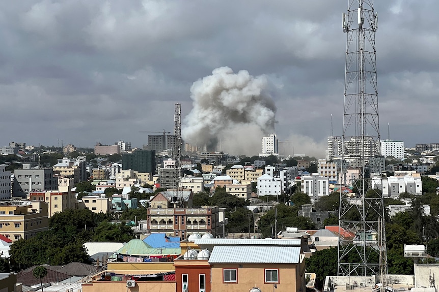 A skyline view shows smoke rising following a car bomb explosion.