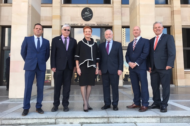 Six current and former One Nation members stand in front of WA Parliament House.