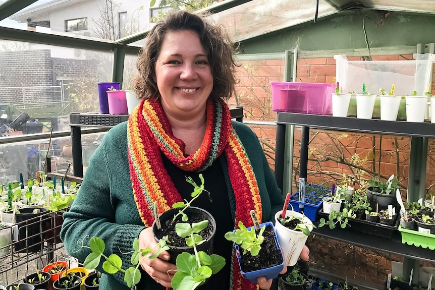 A woman in a green house.