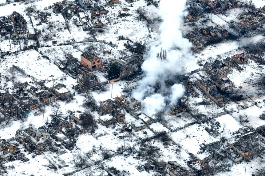 An aerial view of Bakhmut, a snowy village partly destroyed by heavy artillery shelling.