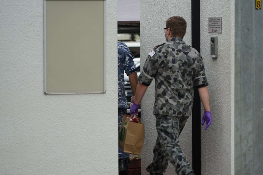 Defence personnel receive a food delivery at the Travelodge motel in Darwin's CBD.