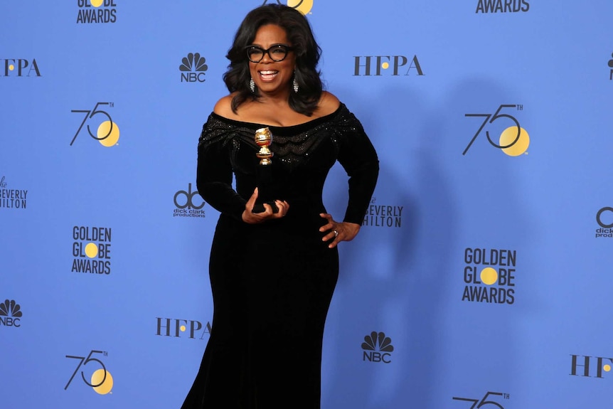 Oprah Winfrey poses backstage with her Cecil B. DeMille Award.