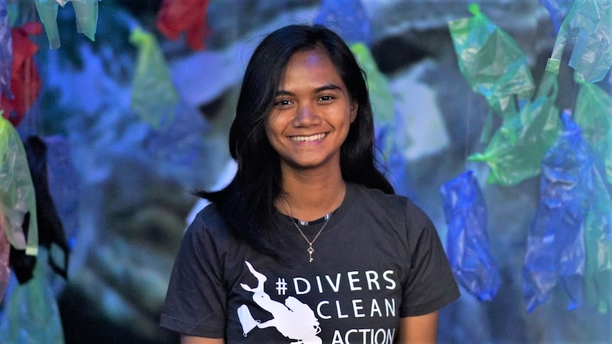 A woman looking and smiling at a camera