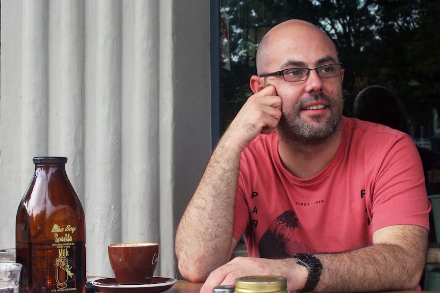 Tom Berry sits at a cafe