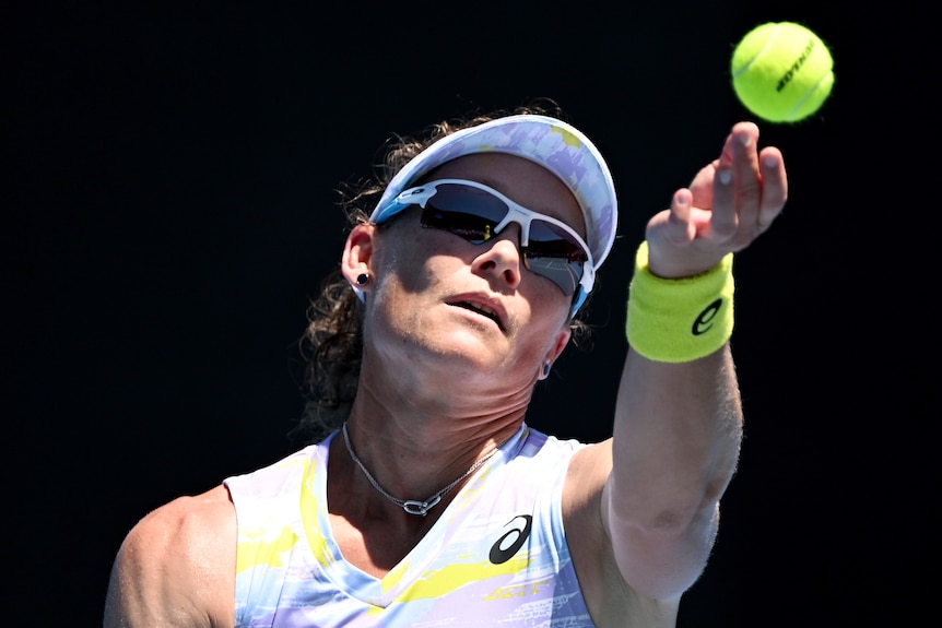 An Australian female tennis player prepares to serve at the Australian Open.