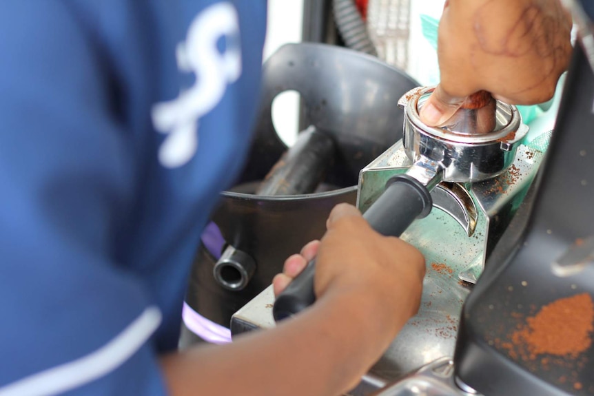 Making coffee, the ground beans pour into the head before tamping