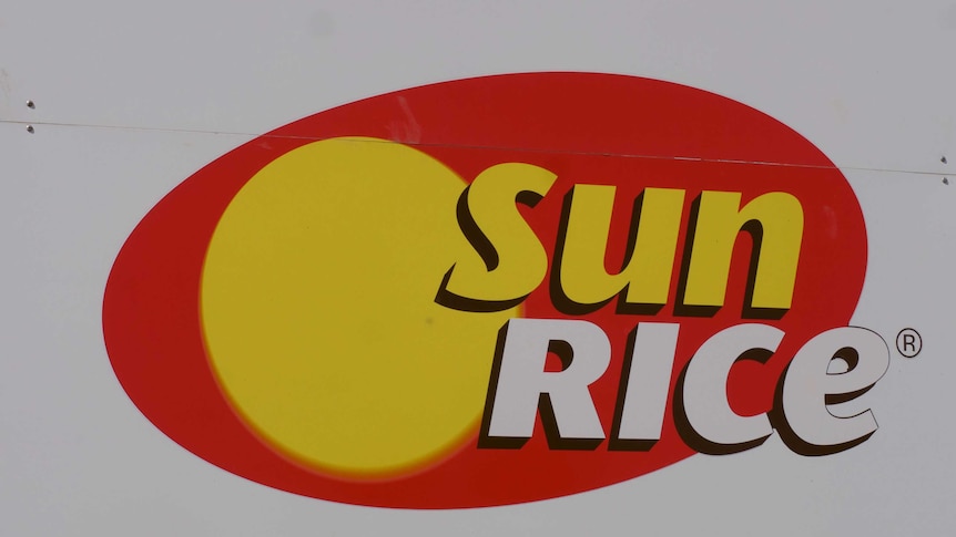 Close up of SunRice Deniliquin Mill sign with SunRice red and yellow logo in centre.