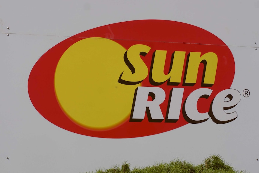 Close up of SunRice Deniliquin Mill sign with SunRice red and yellow logo in centre.
