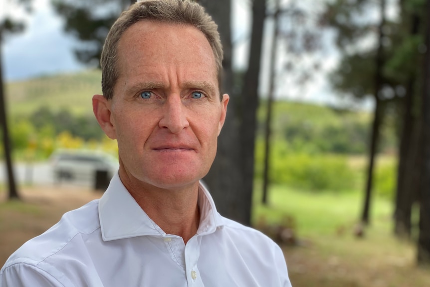 A man wearing a white collared shirt.