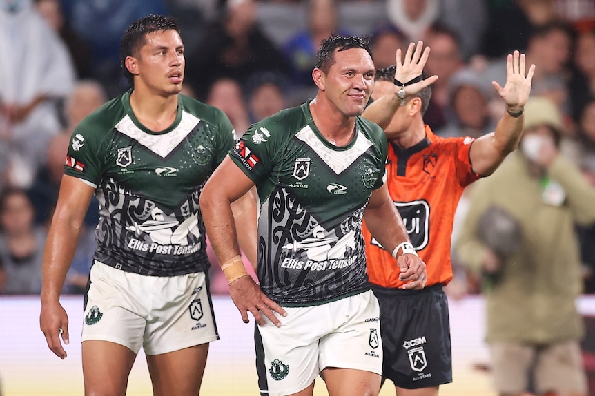 Jordan Rapana of the Māori All Stars runs away as the referee signals 10 minutes.