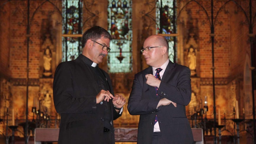The Very Reverend Richard Pengelly talks to music director Joseph Nolan inside Perth's St George's Cathedral.