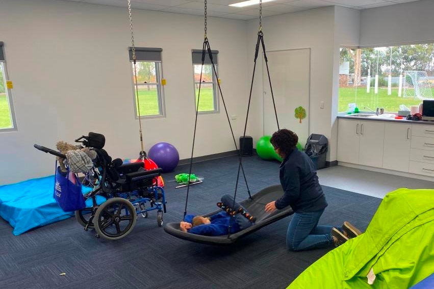 School child in a supported swing in a sensory room at Cobdogla Primary School 