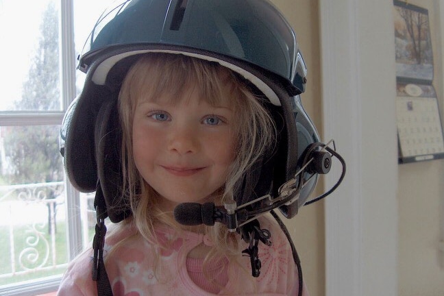 Georgie Arnold, pictured as a young child, wearing a helictoper helmet.