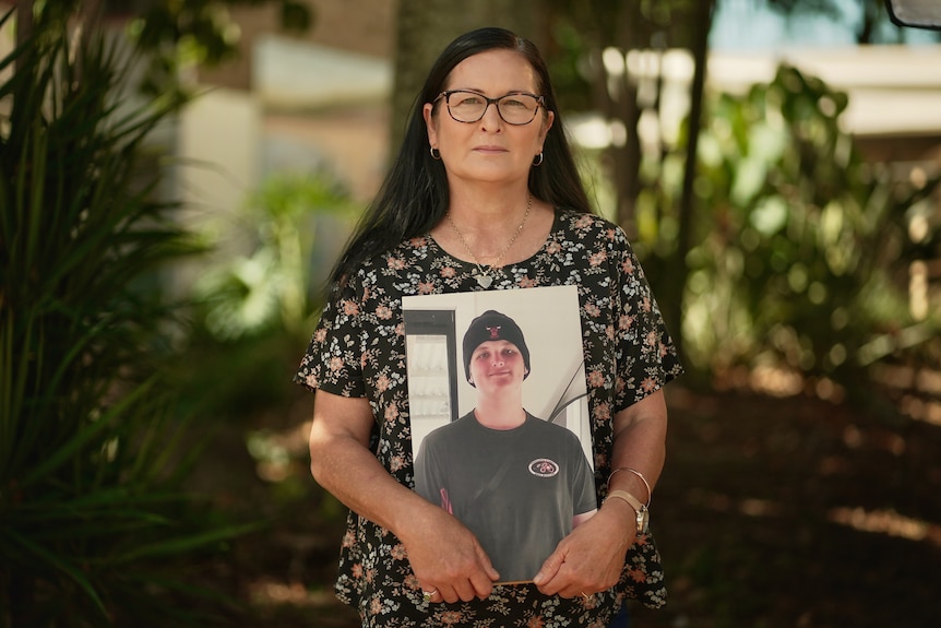 Michelle Liddle holding a photo of her late son, Angus.