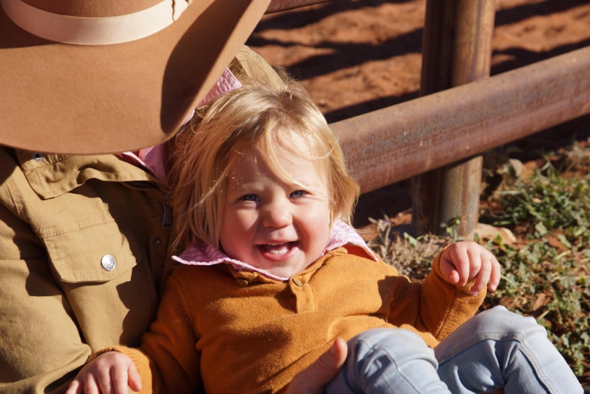 Photo of cattle yards with young family