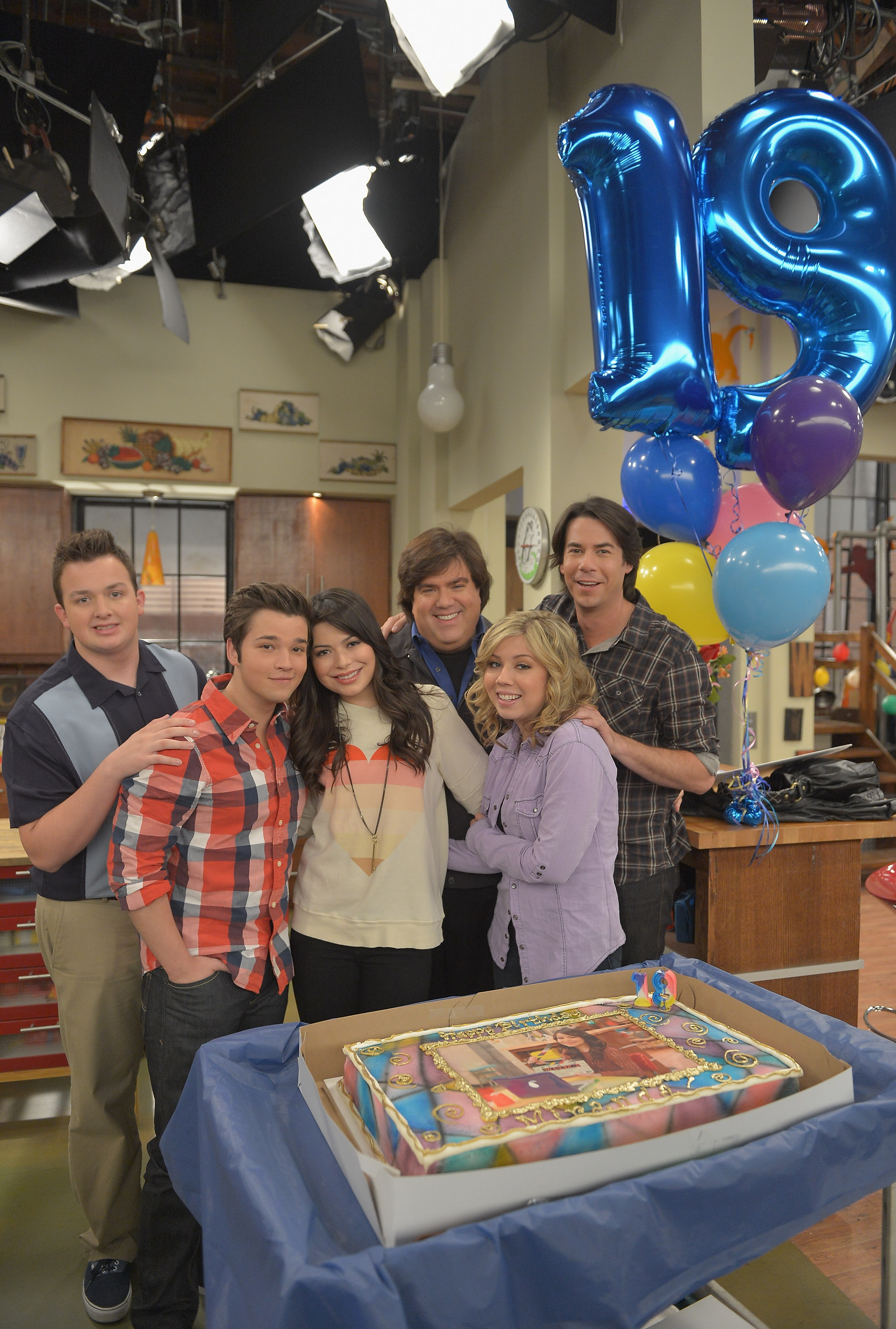 Dan Schneider (third from the right) celebrates Miranda Cosgrove's 19th birthday with the iCarly cast on set in 2012.