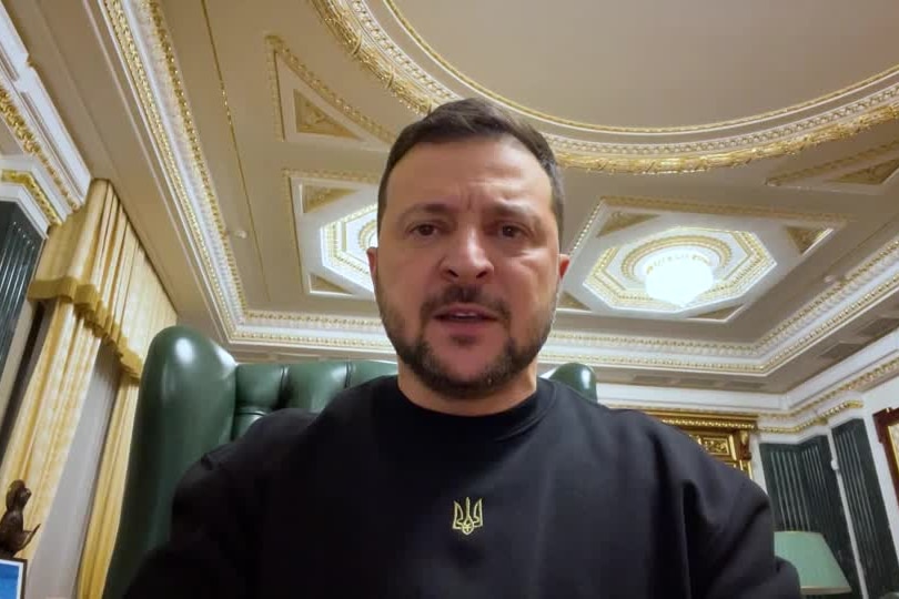 President Volodymyr Zelenskyy sits in a green leather chair in office, on a video call. 