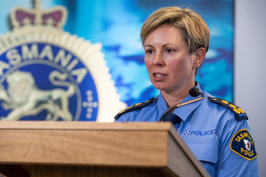 A female police officer at a lecturn.